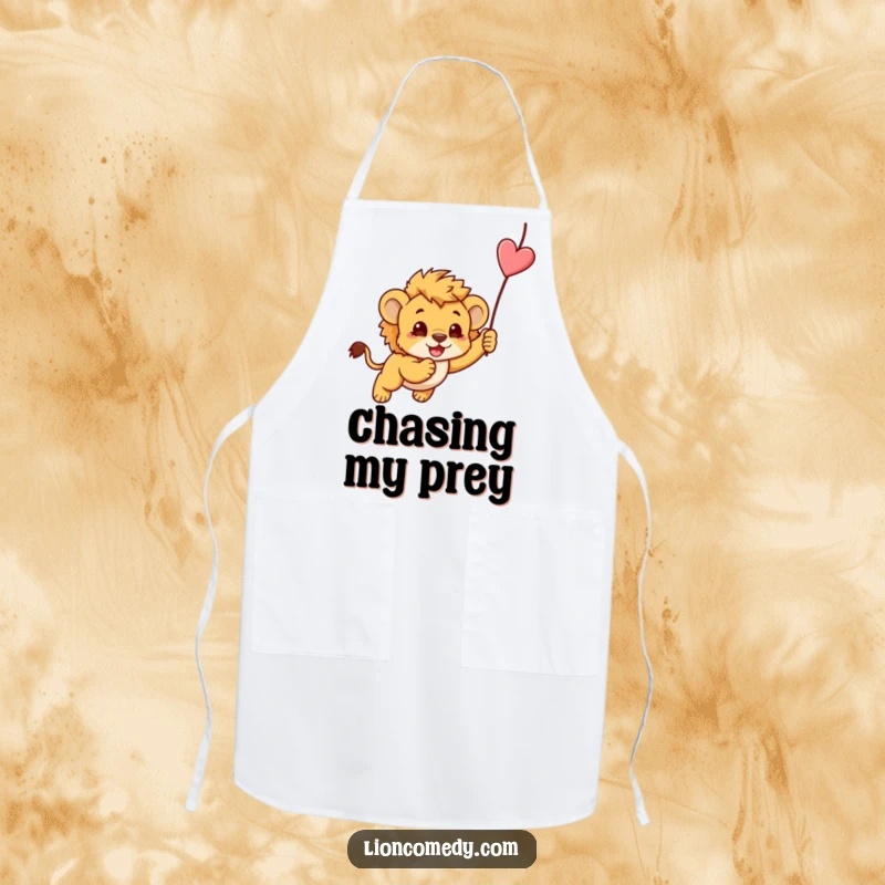 Funny cooking apron featuring a kawaii lion cub playfully pouncing on a string, perfect for kitchen humor.