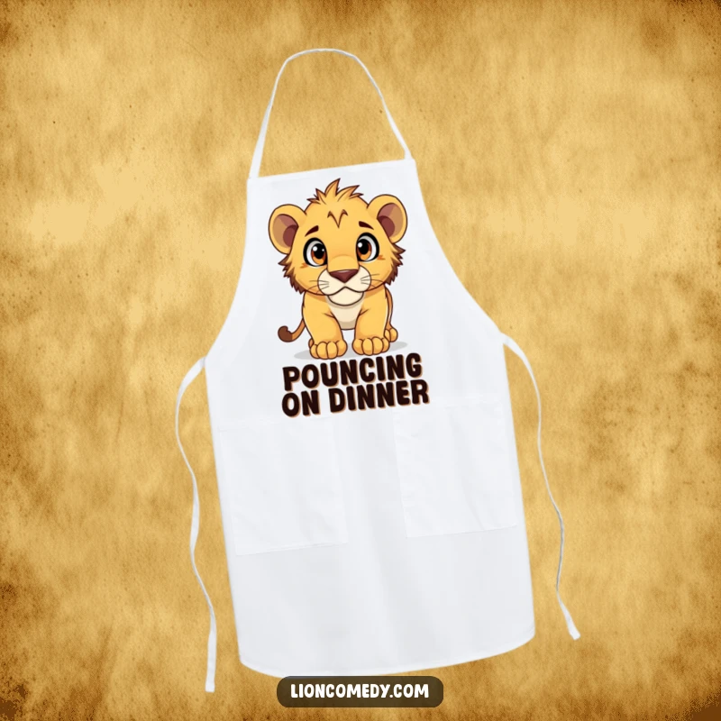 Funny Apron depicting a lion cub pouncing with wide, curious eyes, ready to tackle any culinary adventure.