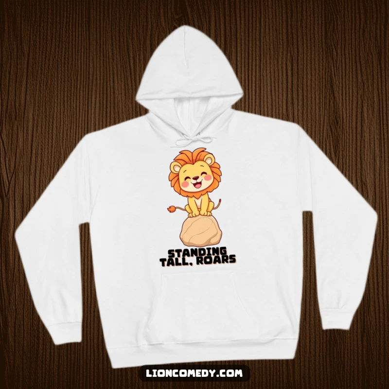 Funny lion balancing hoodie showcasing a joyful lion finding its footing on a small rock, providing warmth and humor.