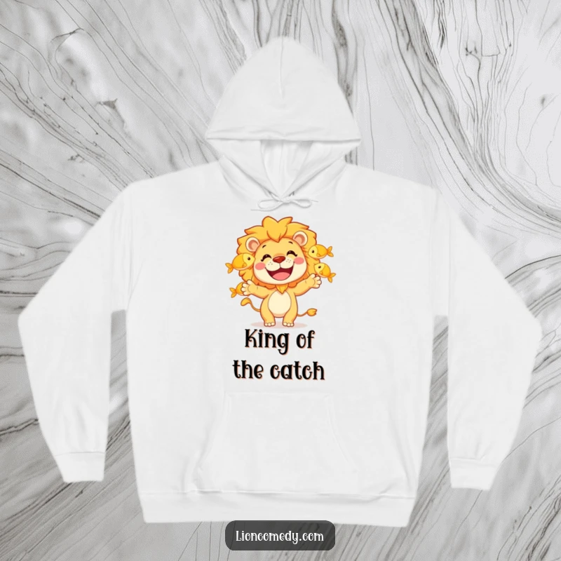 Funny hoodie depicting a grinning lion character expertly juggling three golden fish, offering warmth and a hearty dose of humor.