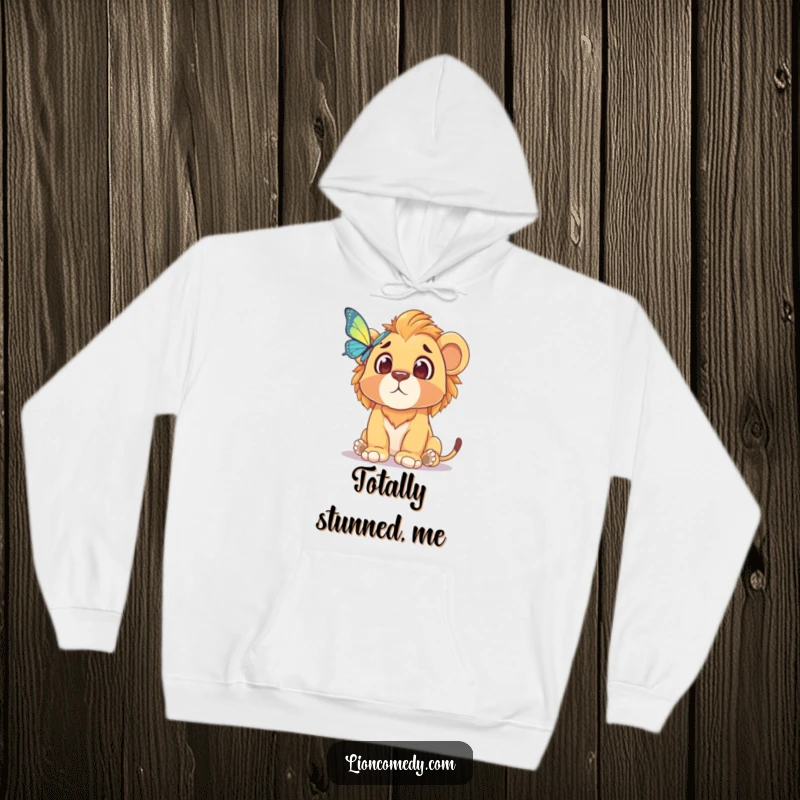 Funny hoodie with a lion cub's comical, surprised face as it observes a butterfly, offering warmth and a touch of humor.