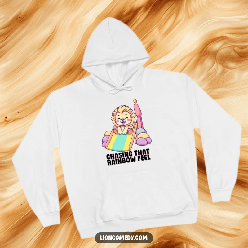 Funny Hoodie: A tiny lion happily slides down a colorful rainbow, radiating pure glee. A comfortable and humorous gift for all ages.