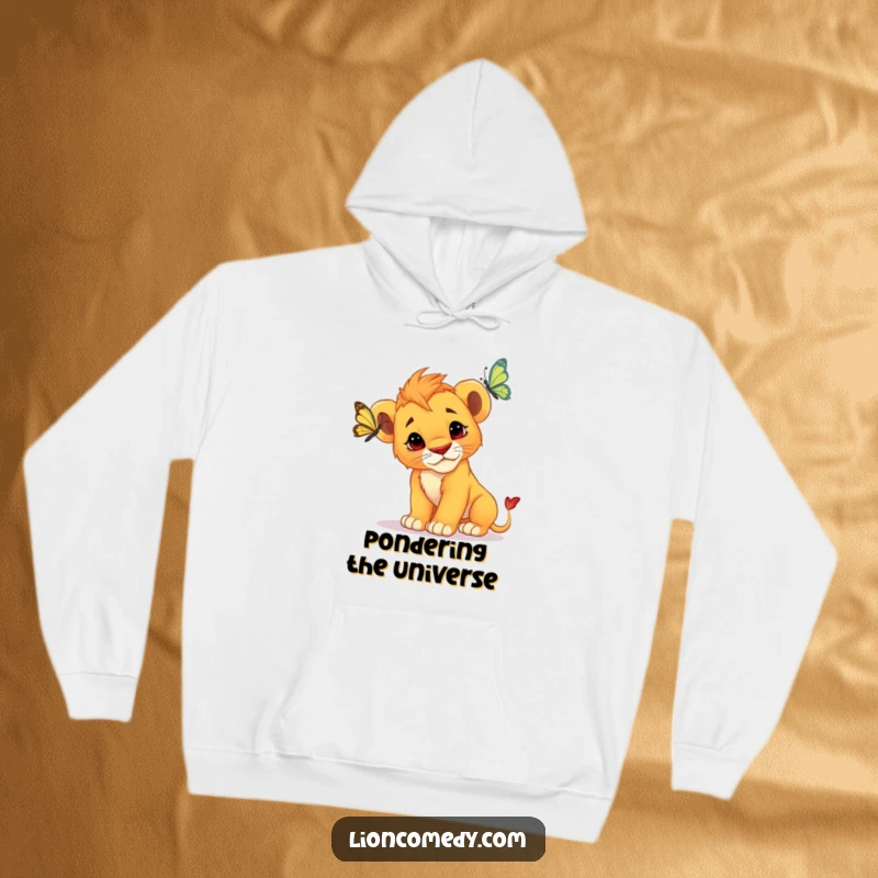 Funny Lion Cub Hoodie: An inquisitive cub with a tilted head stares intently at a fluttering butterfly, showing pure curiosity.