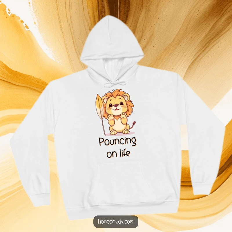 Funny hoodie displaying a spirited lion cub in mid-pounce pose, eyes locked on a feather, ready for action.