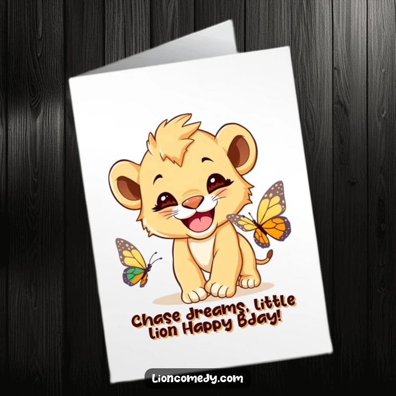 Funny Free Printable Birthday Card: A cute lion cub with a huge grin, playfully chasing a colorful butterfly.