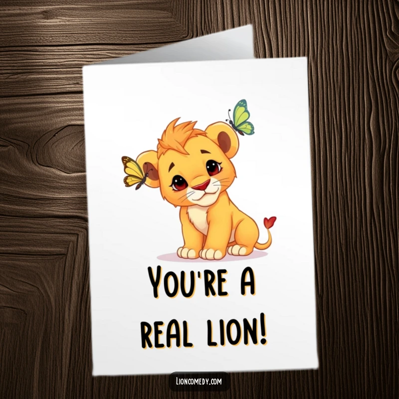 Free Printable congratulations card showing a curious lion cub looking intently at a butterfly, perfect for celebrating achievements.