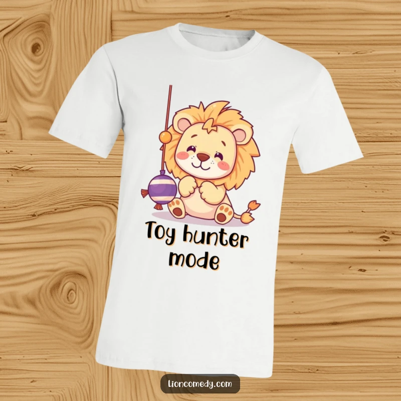 Funny t-shirt of a kawaii lion batting at a dangling string toy with its playful paws, looking mischievous.