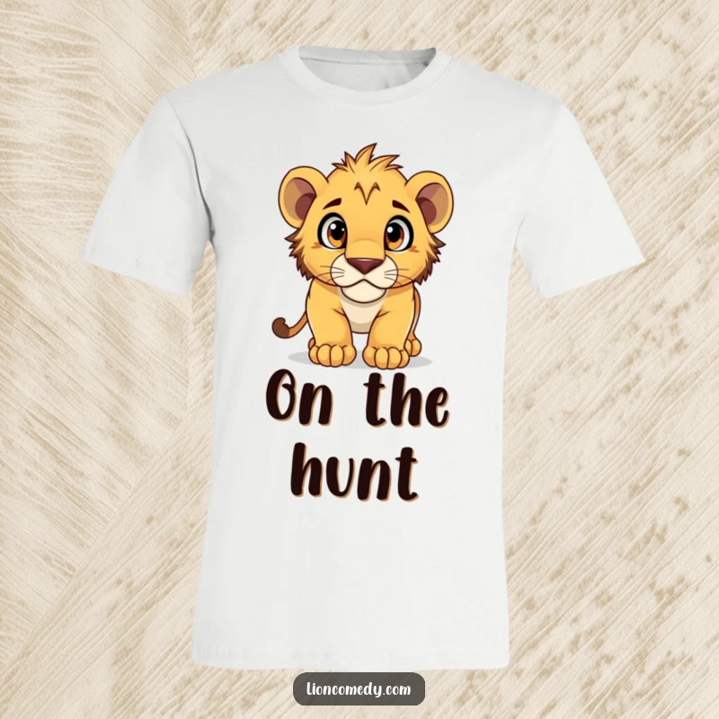 Funny T-Shirt depicting a lion cub pouncing with wide, curious eyes, ready for adventure and fun.