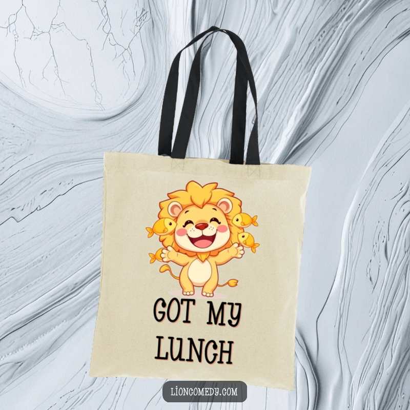 Funny tote bag featuring a happy lion character gleefully juggling three golden fish with a wide, amusing grin.